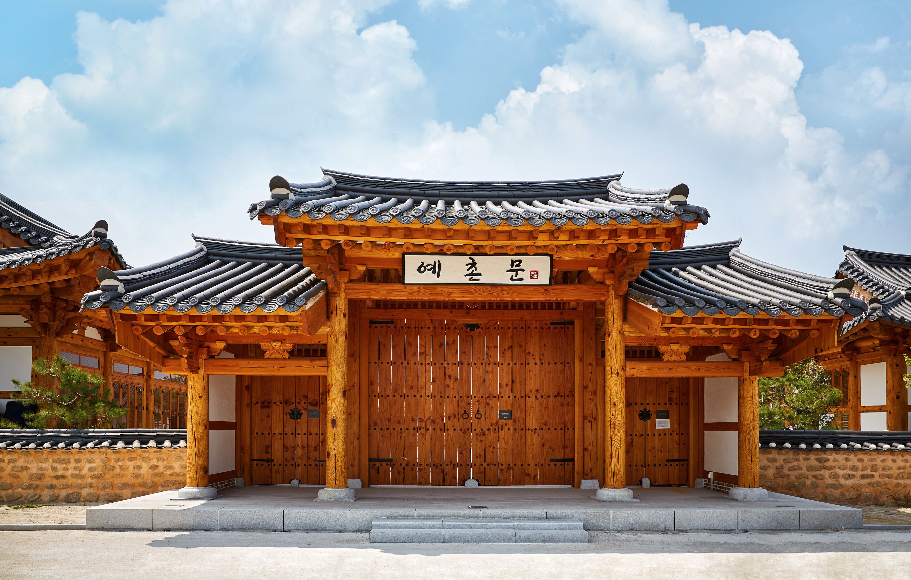 A traditional Korean gate with a wooden structure and tiled roof.
