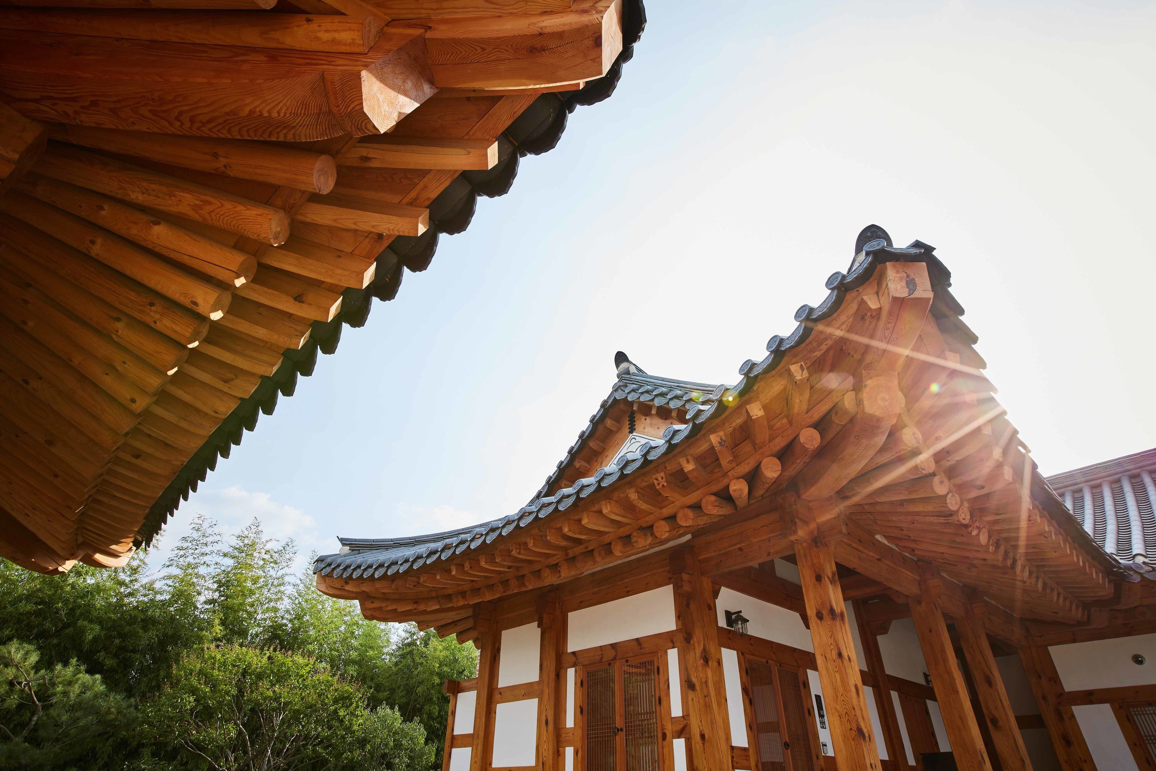 A traditional wooden building with a curved roof and wooden beams.
