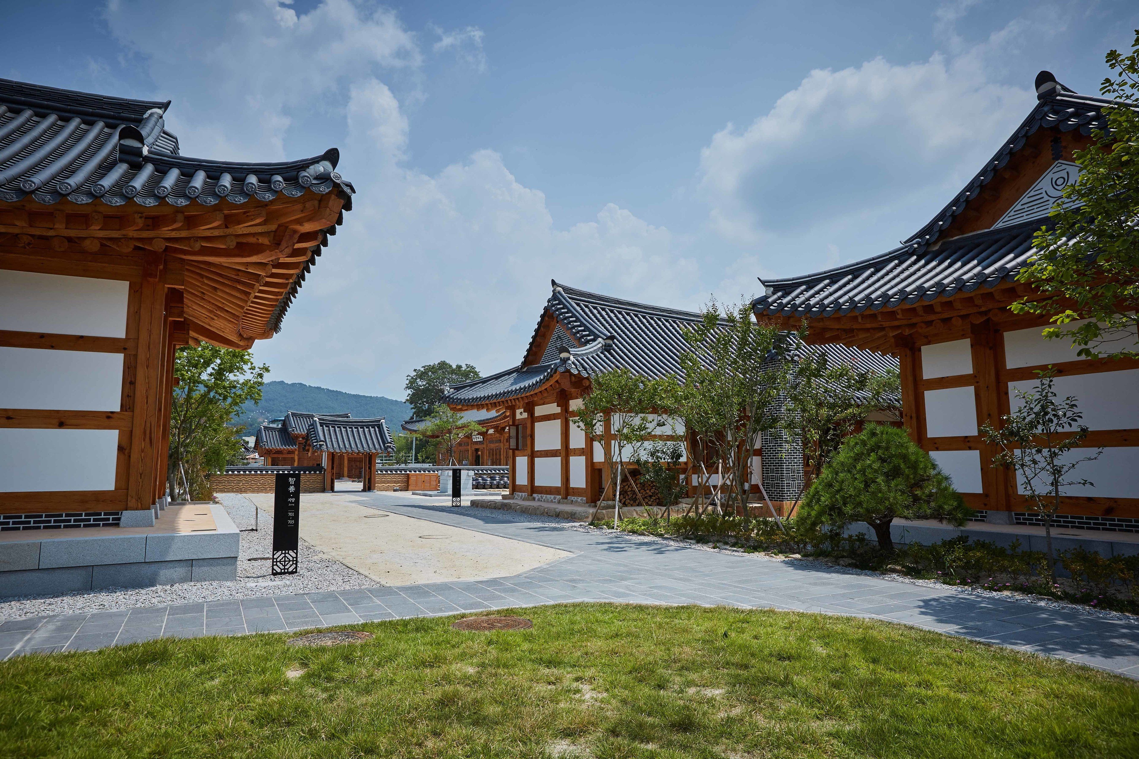 A traditional Korean-style building complex with wooden structures and tiled roofs.