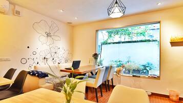 Enjoy meals and work sessions in this stylish dining area with a large window offering a view of the outdoor balcony.