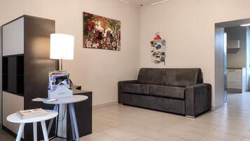 Standard Townhome, Garden View | Living area | Flat-screen TV