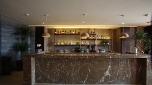 A bar area with marble countertops, shelves of bottles, and pendant lighting. - Mangrove Tree Resort World - Elader Palm (Sanya)
