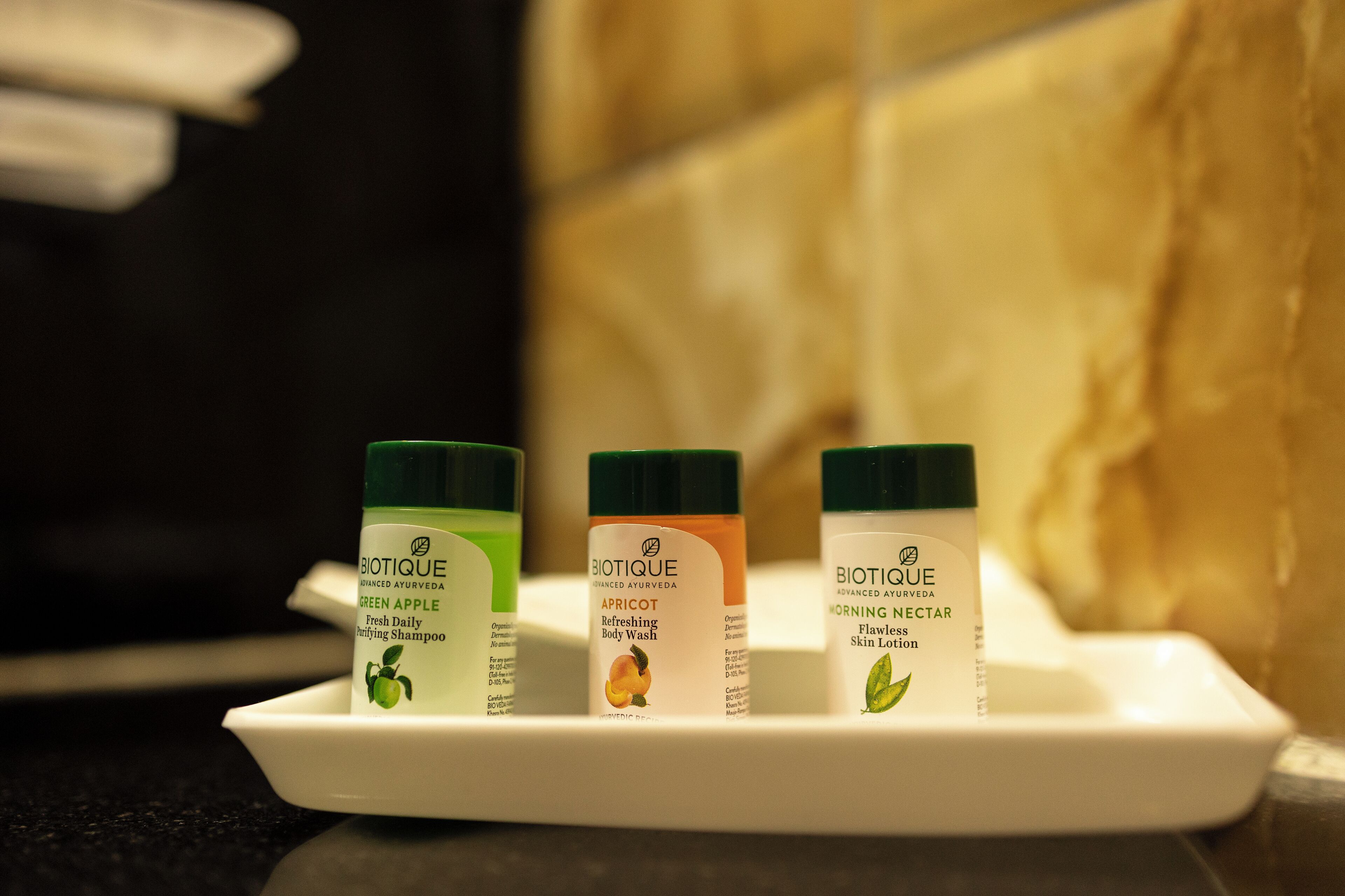 Three Biotique body wash bottles on a white tray.