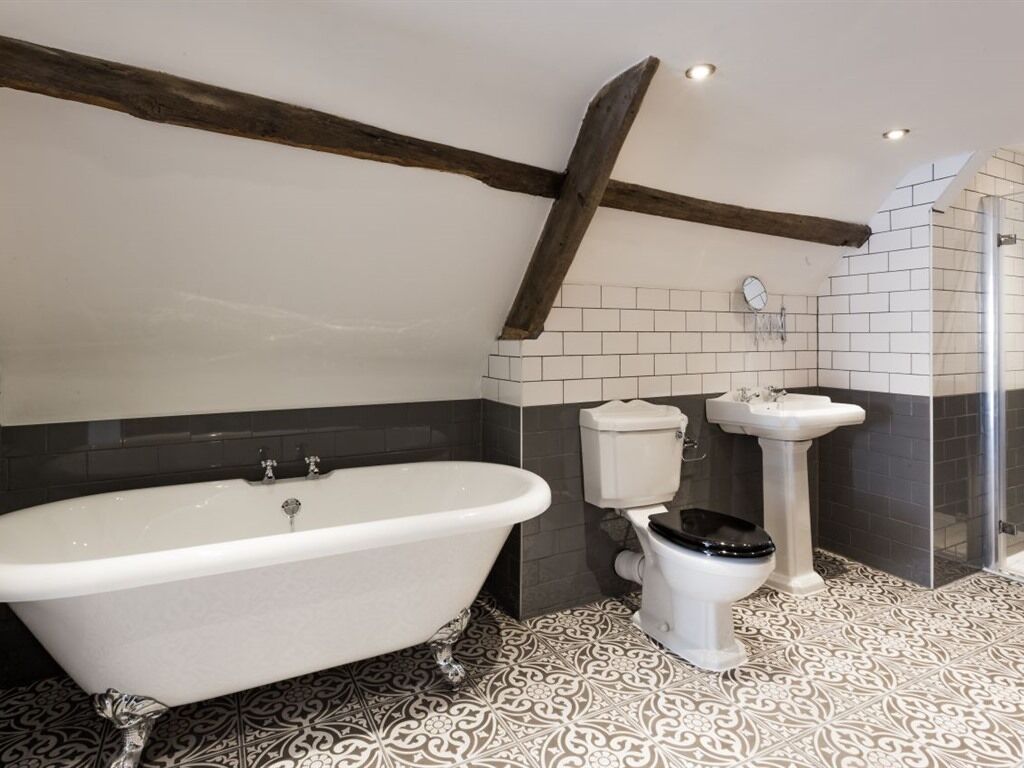 A bathroom with a freestanding bathtub, a toilet, and a sink.