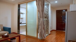 A modern living room with a sliding glass door leading to a kitchen area. - Live Inn Luogang Wanda Square Branch (Guangzhou)