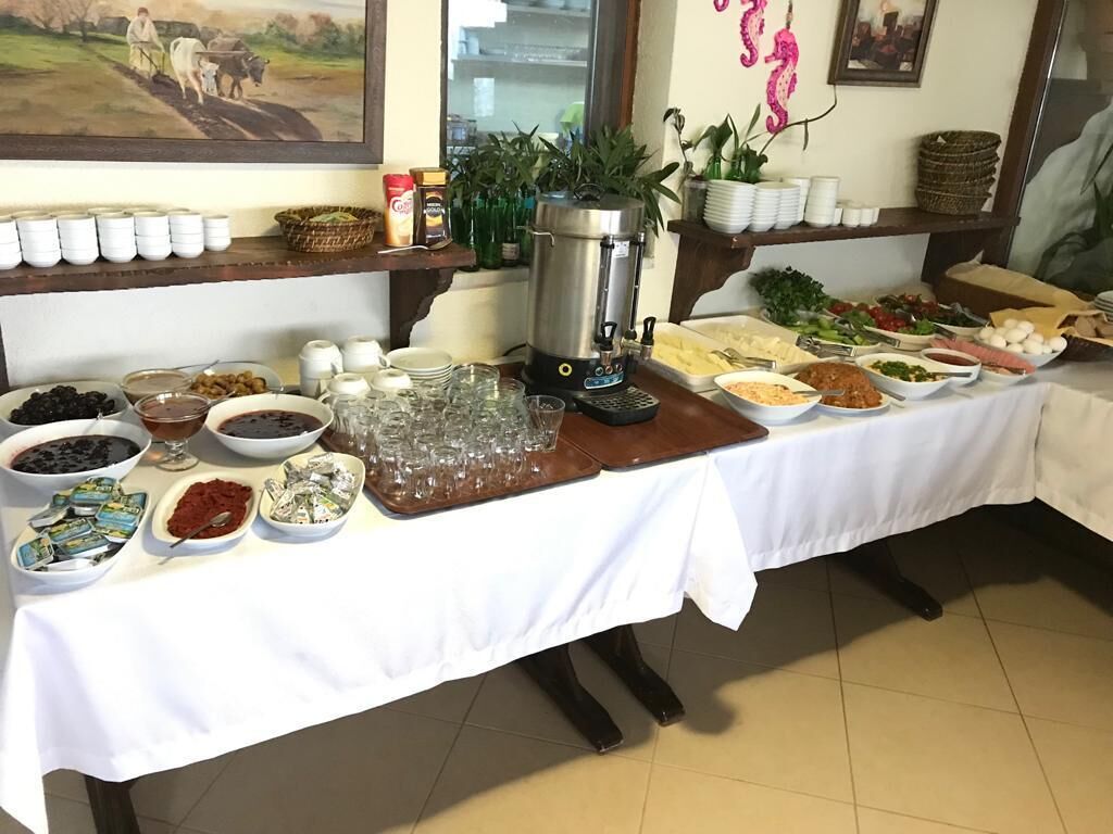 A buffet table with various food items and a coffee machine.