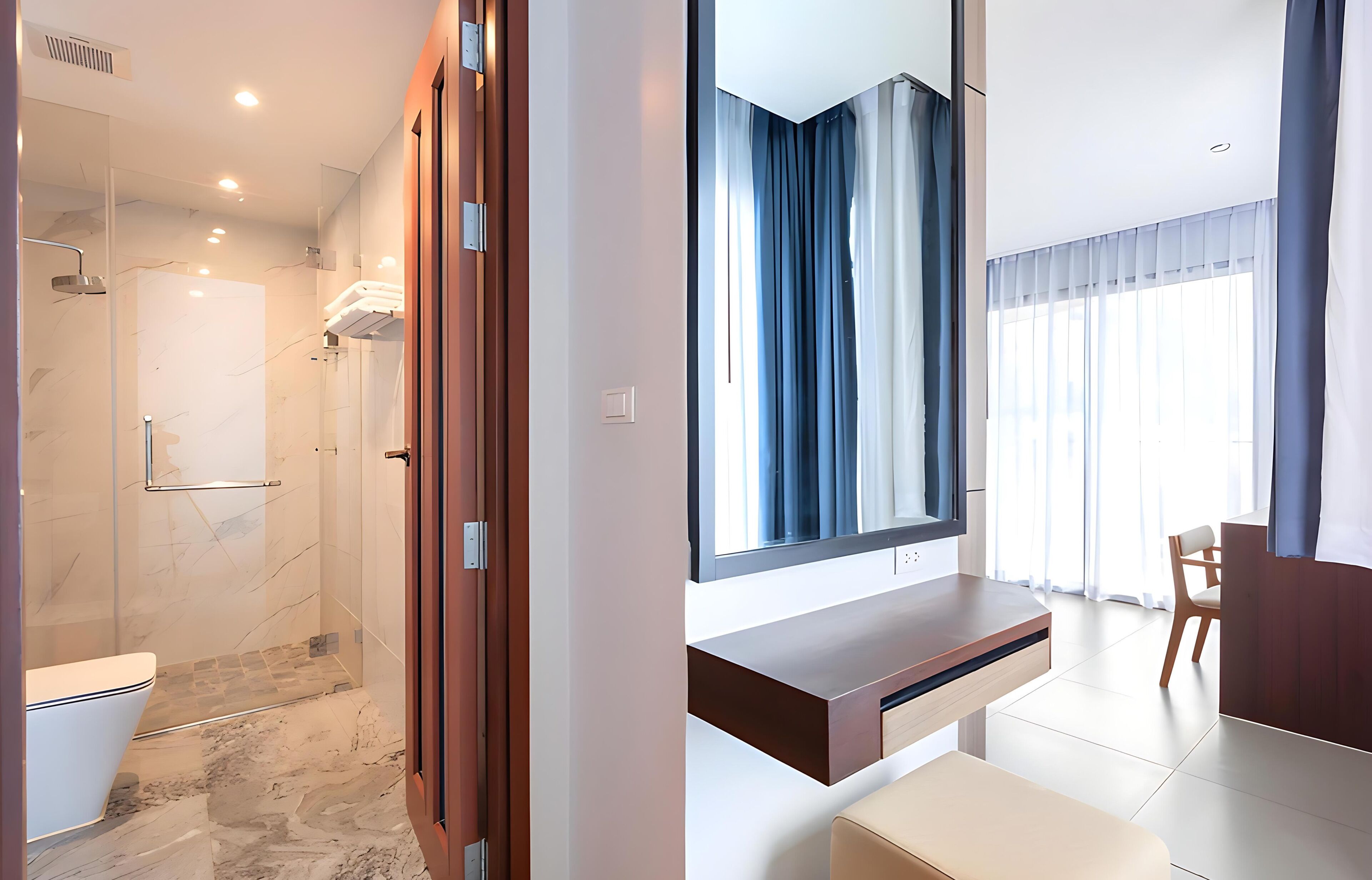 A modern bathroom with a shower, toilet, and vanity.