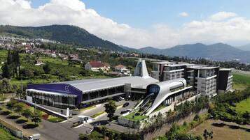 A modern building with a unique architectural design, featuring a prominent curved structure and a central tower.