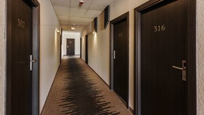 A hallway with doors numbered 302, 315, and 316.