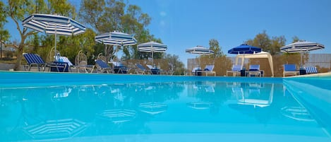 Outdoor pool, open 11:00 AM to 7:00 PM, pool umbrellas, pool loungers
