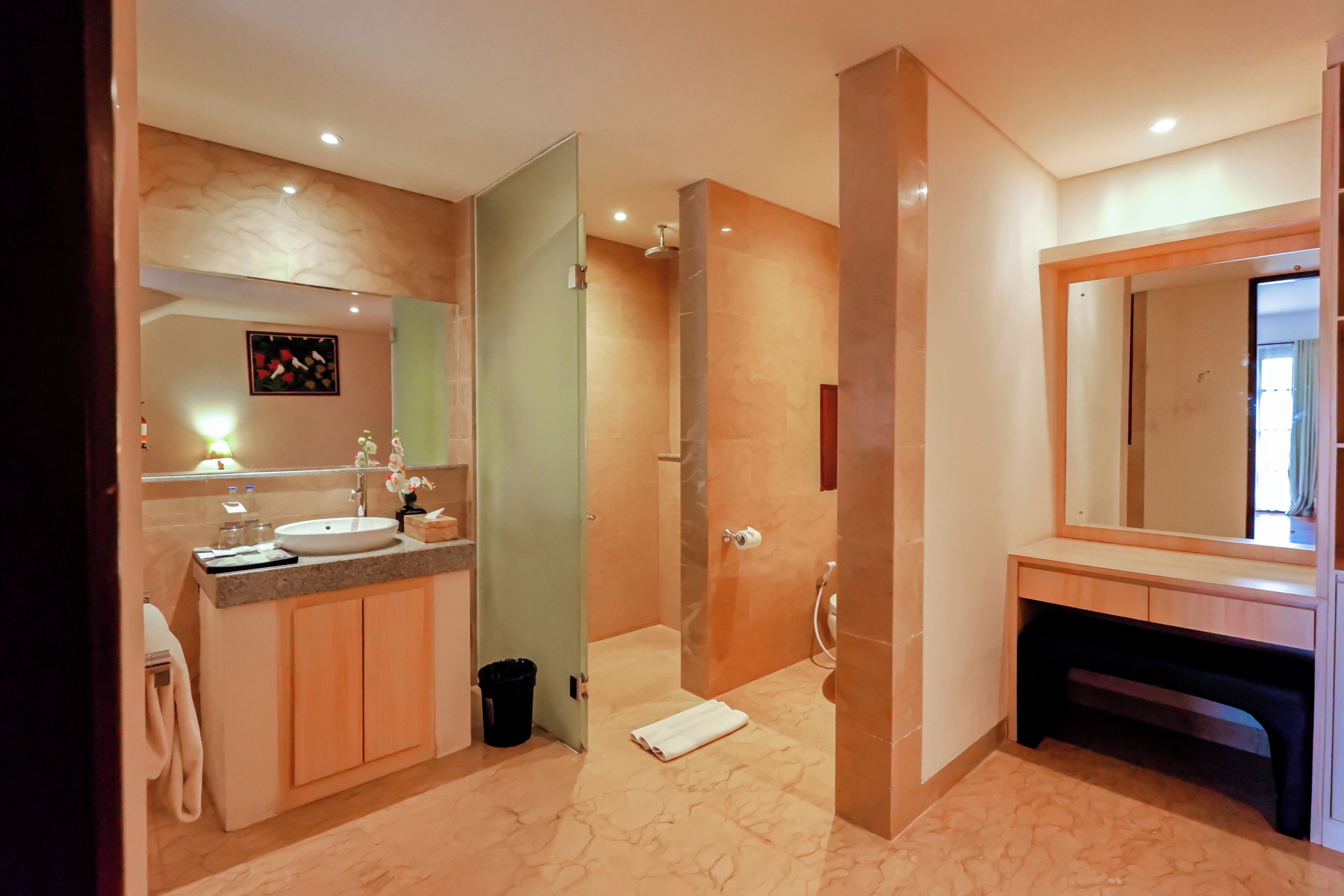 A modern bathroom with a vanity, sink, and shower.