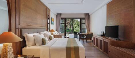 A spacious hotel room with a large bed, a television, a desk, and a view of the outdoors.