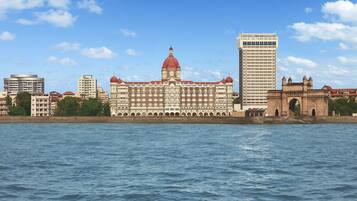 A large building with a prominent dome and arched windows, situated by a body of water.