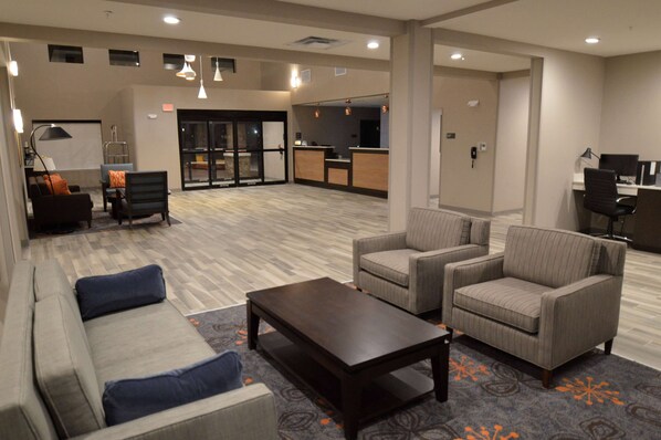 Welcome to our lobby, featuring a reception desk, comfortable seating area and coffee table.