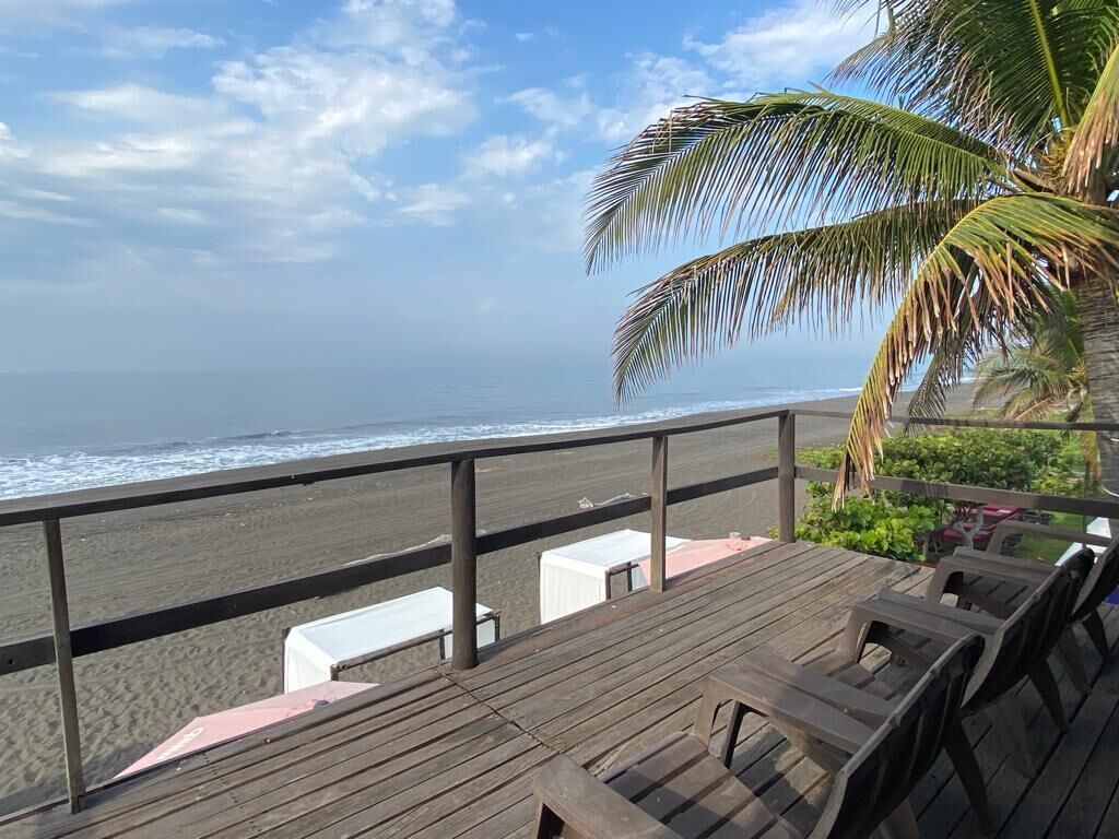 A wooden deck with a view of the ocean.