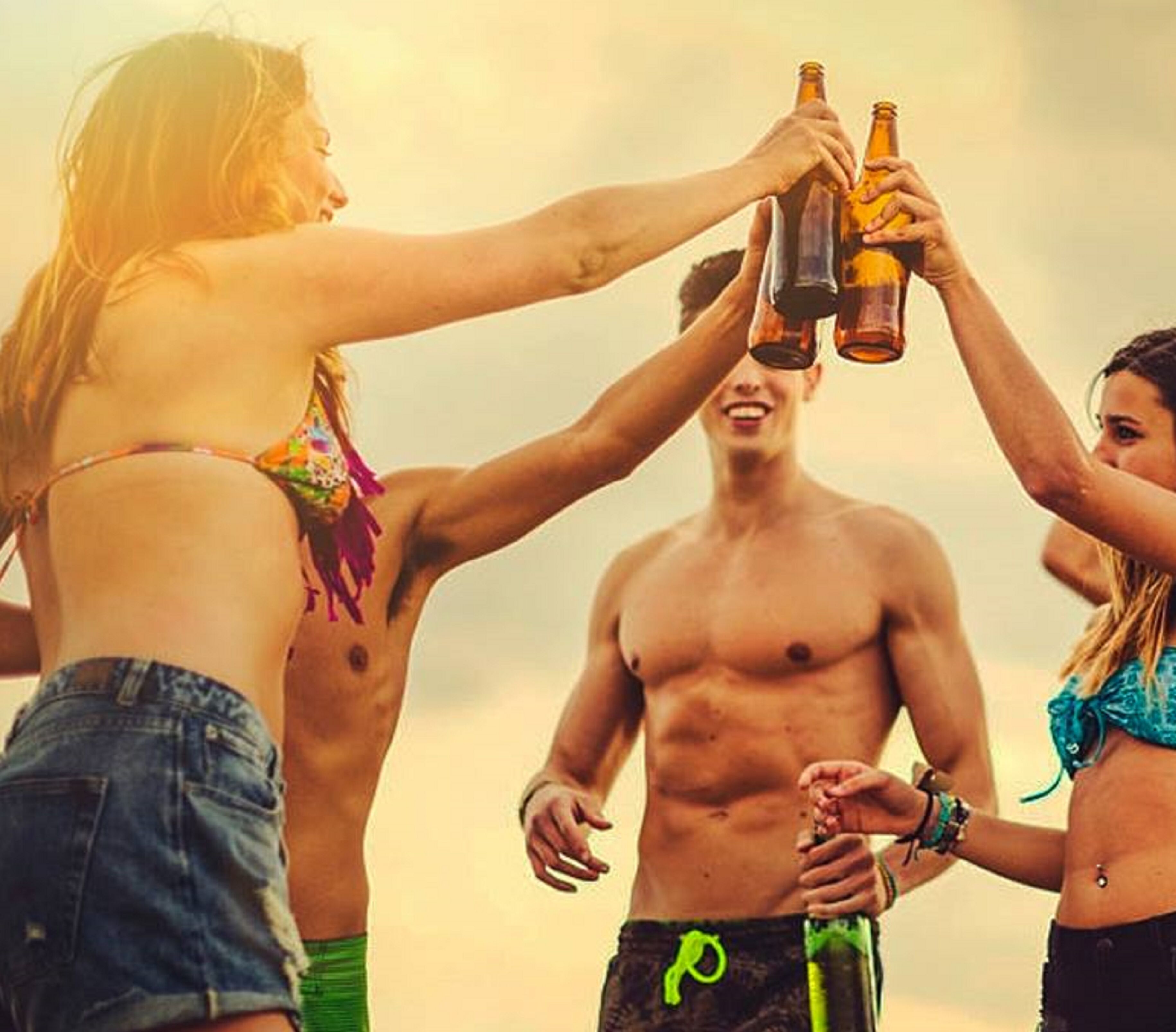A group of people toasting with beer bottles.
