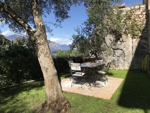 Relax in a serene outdoor seating area surrounded by lush greenery and a majestic mountain view.