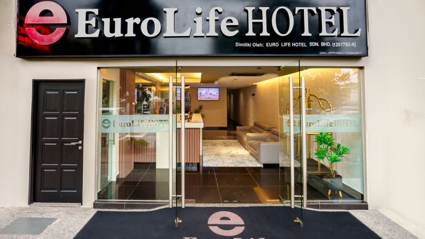 The entrance of the EuroLife Hotel with a reception area visible through the glass doors. - Alaxis Hotel (Kuala Lumpur)