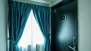A room with a door marked "401" and a window with teal curtains. - Alaxis Hotel (Kuala Lumpur)