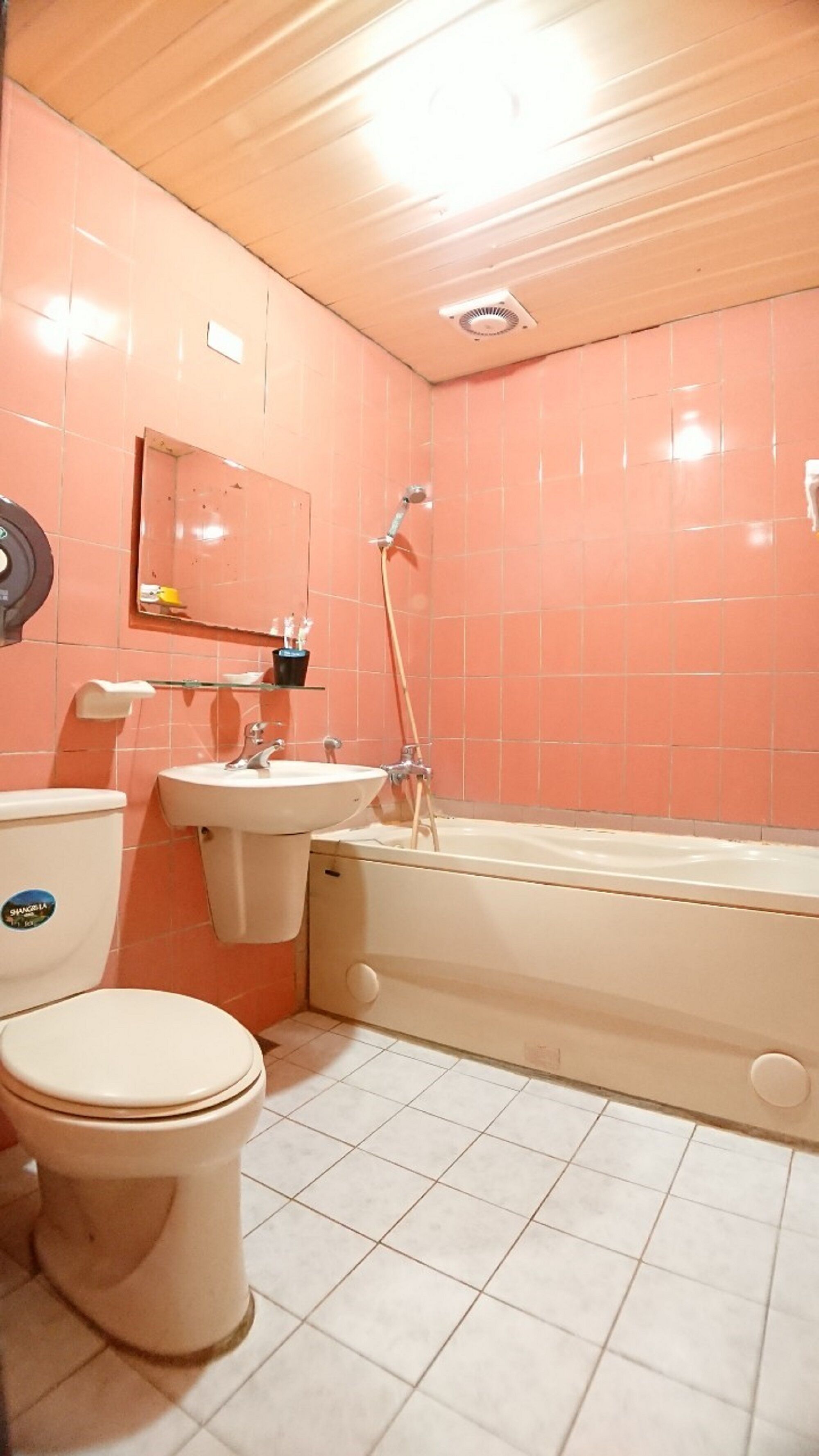 A bathroom with a toilet, sink, and bathtub.