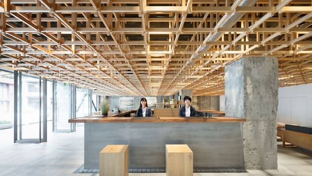 A reception area with a wooden ceiling and a concrete counter. - KUMU Kanazawa by The Share Hotels (Kanazawa)