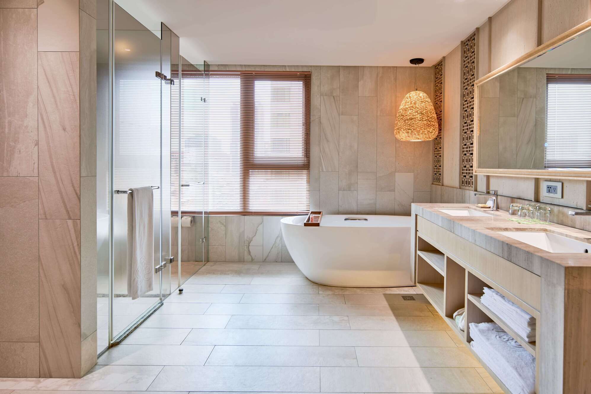 standard family room | bathroom | separate bathtub and shower, deep-soaking bathtub, hair dryer, slippers