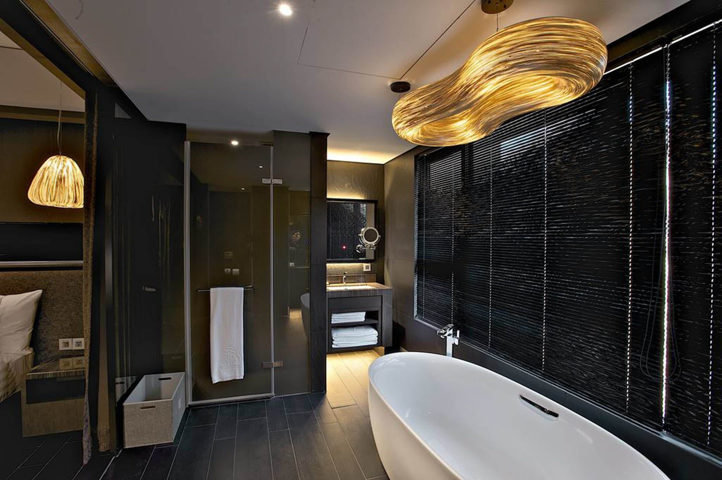 deluxe family room | bathroom | separate bathtub and shower, deep-soaking bathtub, hair dryer, slippers