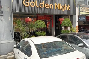 A storefront with a sign reading 'Golden Night' and a car parked in front. - Golden Night Hotel Sunway (Subang Jaya)