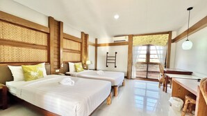 A hotel room with two beds, a desk, and a chair.