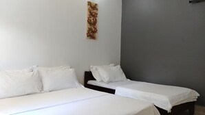 A room with two single beds, white bedding, and a decorative wall piece. - Nungwi House (Nungwi)