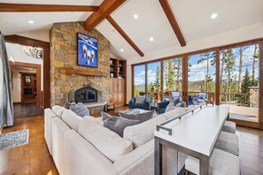 Relax in a cozy living area with a fireplace, comfortable seating, and a scenic view.