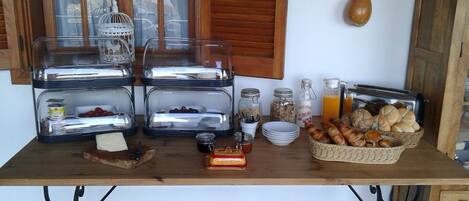 A breakfast buffet with various food items and condiments.