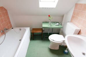 Shower, hair dryer, slippers, towels
