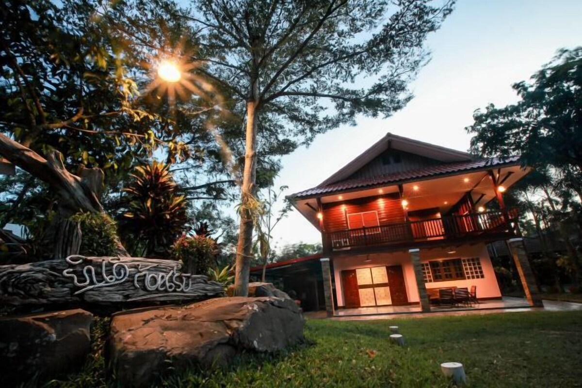 A modern house with a balcony and a well-lit entrance.