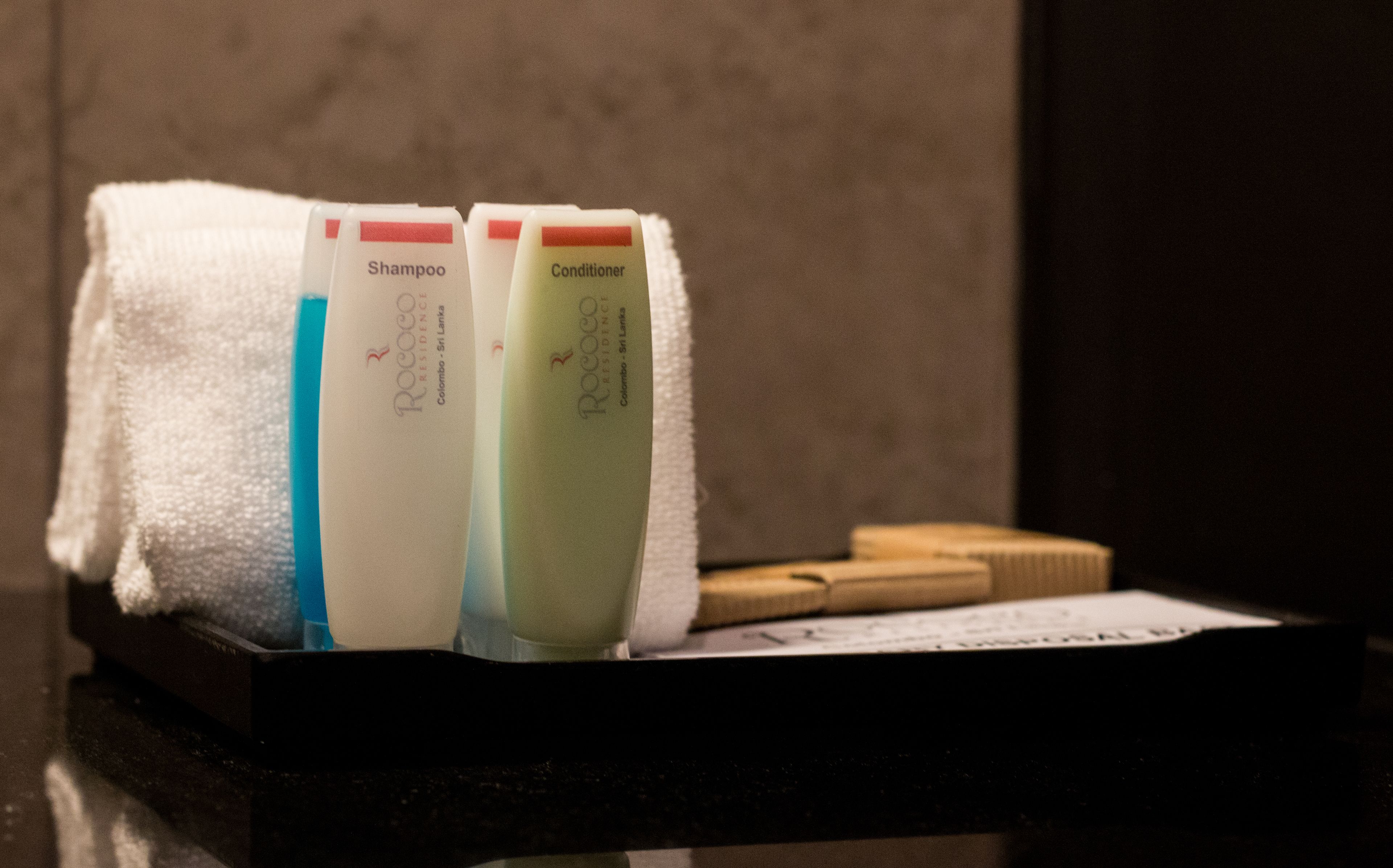 Toiletries in a black tray on a countertop.