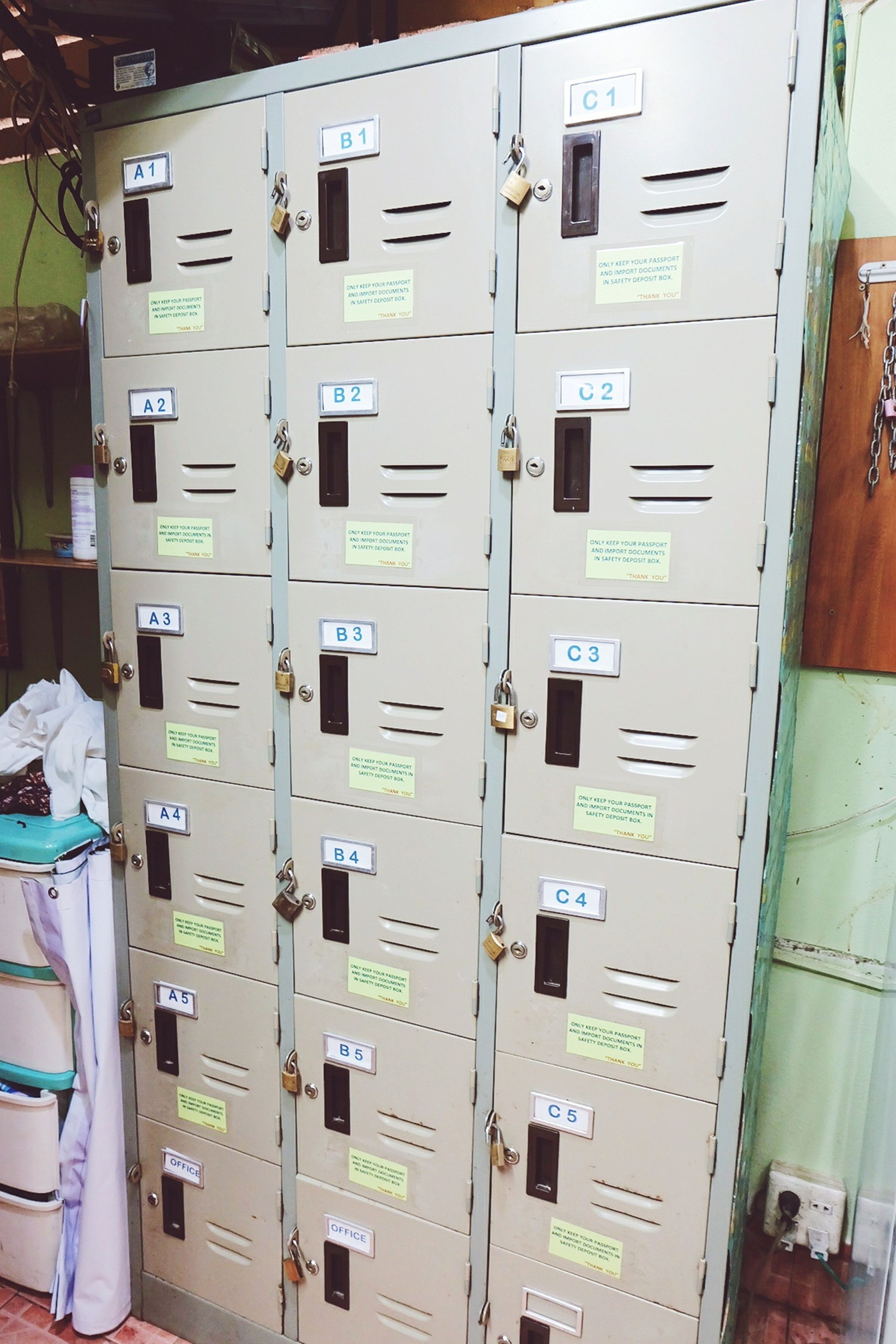 A row of metal lockers with numbered labels and a sign indicating they are for passport and document storage.