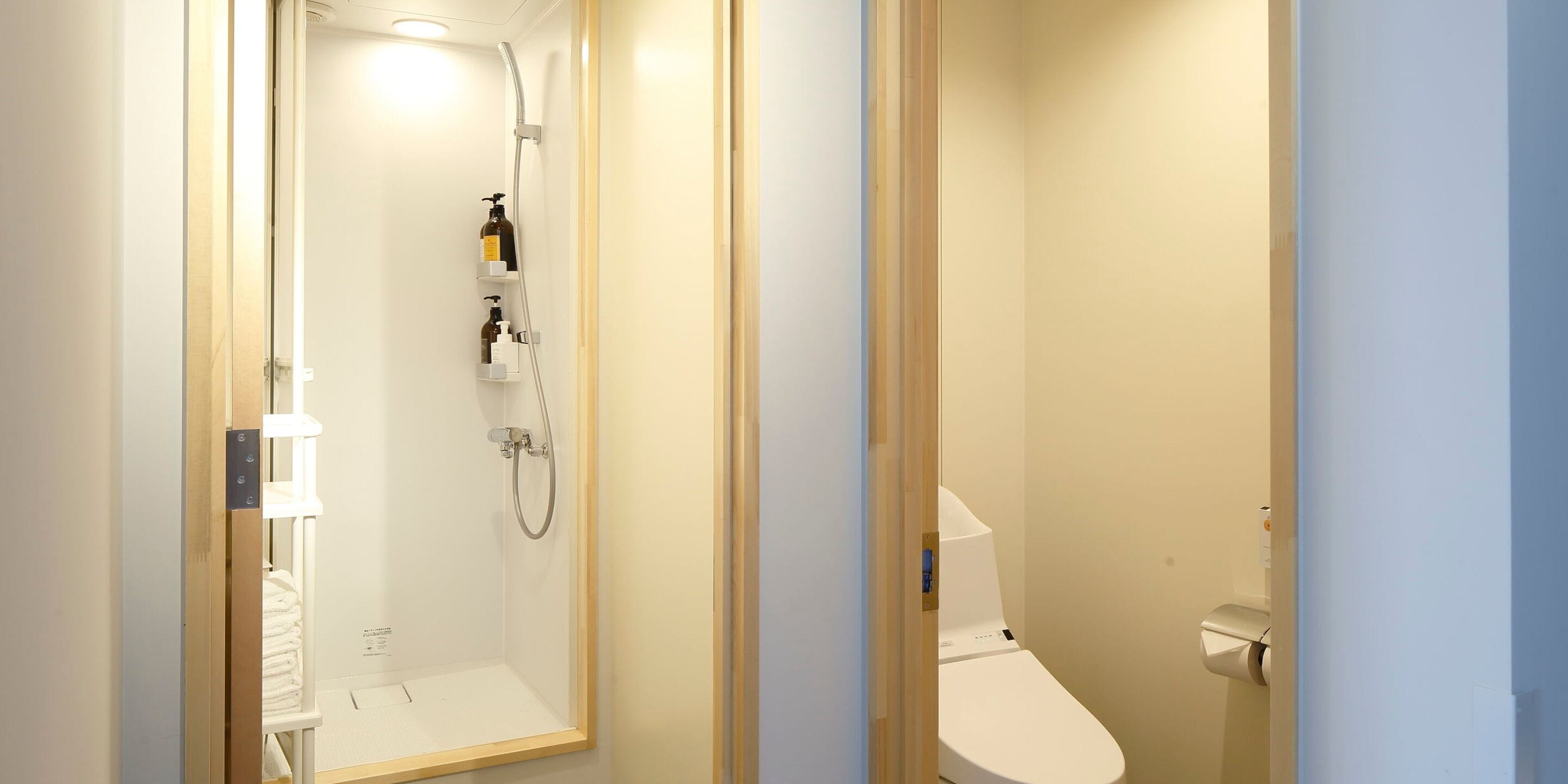 A modern bathroom with a shower, toilet, and storage shelves.