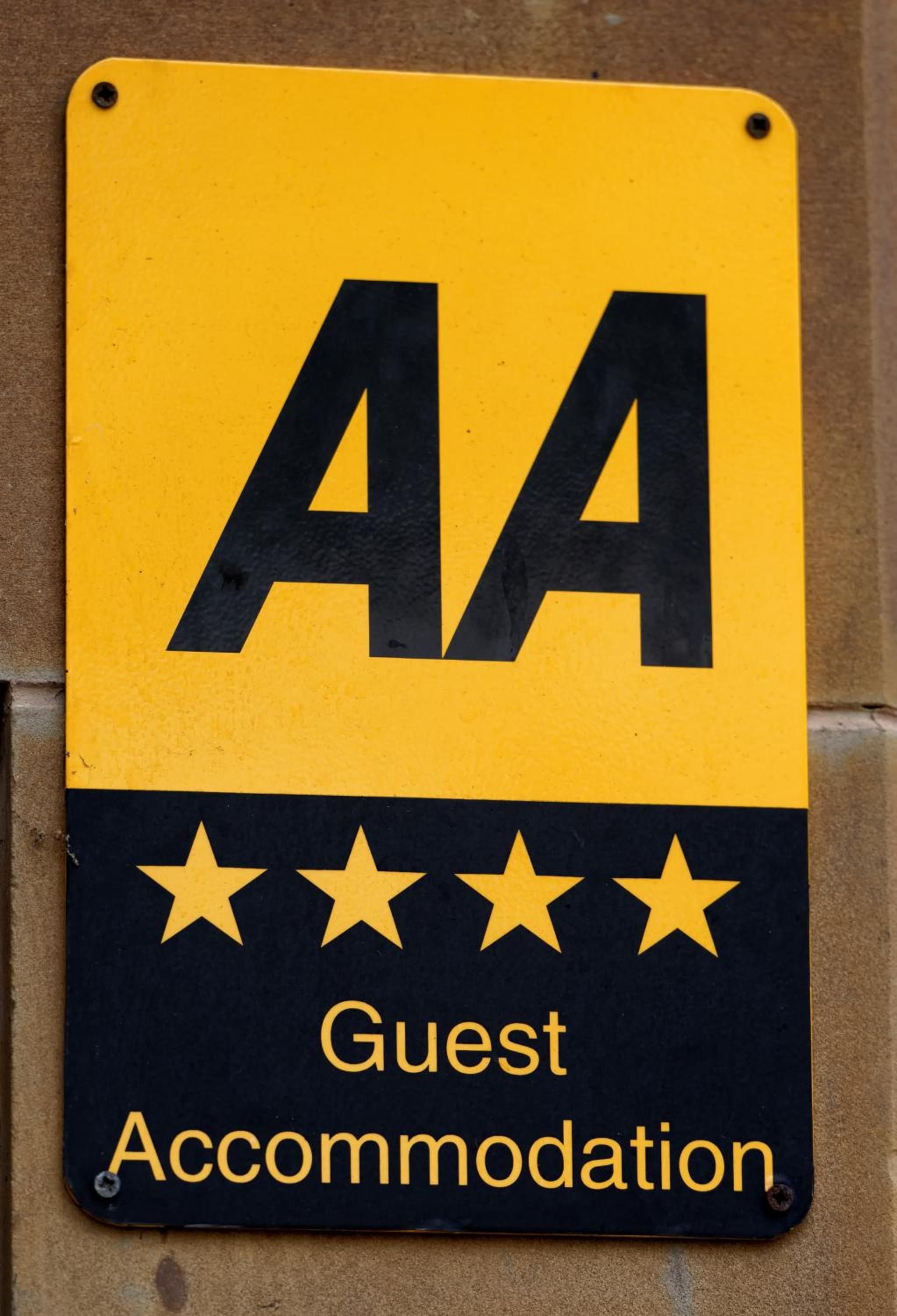 A sign with 'AA' and 'Guest Accommodation' indicating a guest accommodation service.