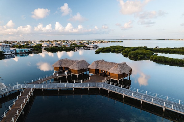 A water-based resort with overwater bungalows connected by a wooden walkway.