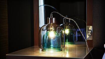 A room with a mirror reflecting two glass bottles on a wooden surface.