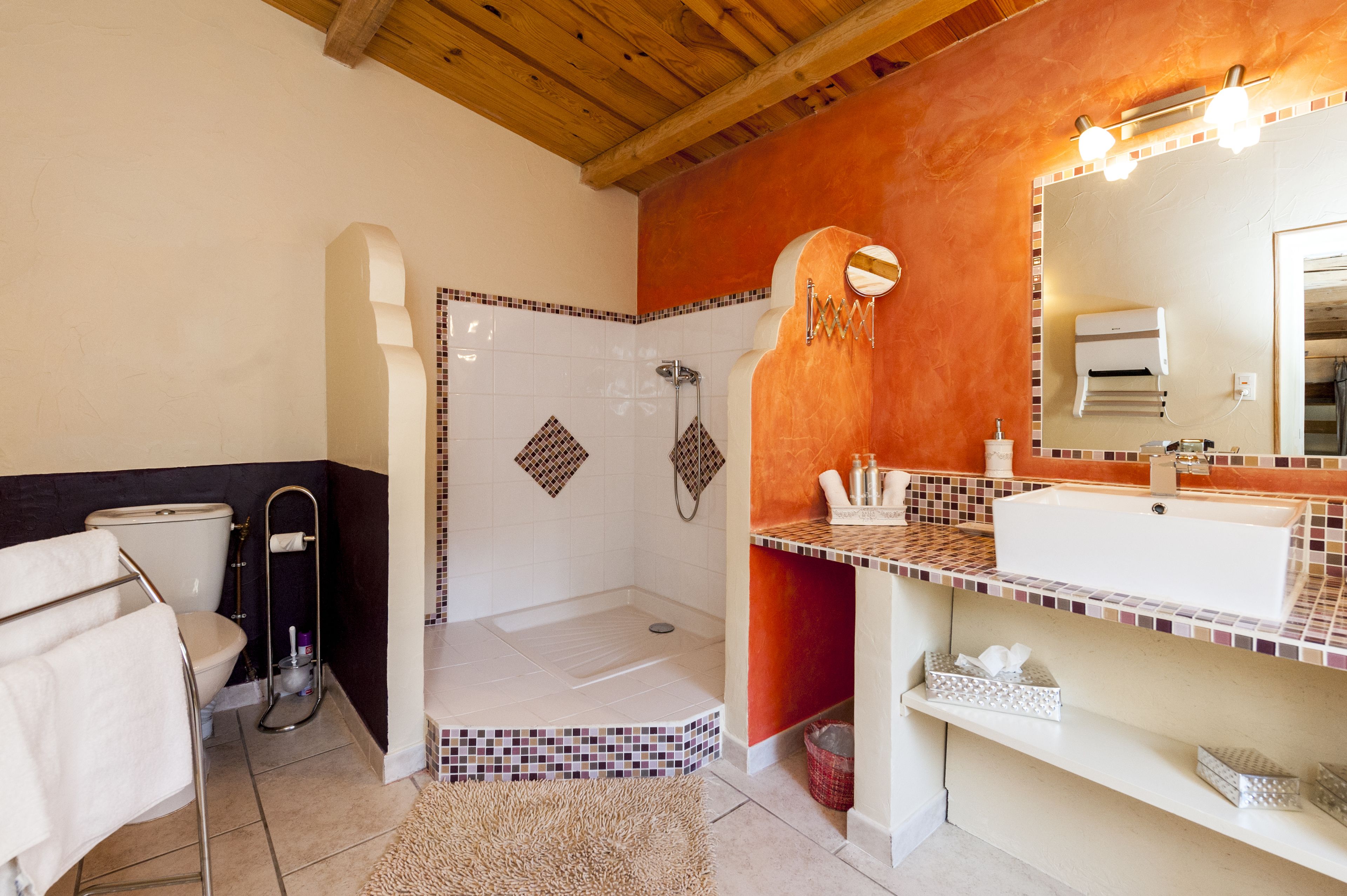 A bathroom with a shower, toilet, and sink.