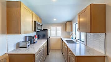 Studio Deluxe, 1 grand lit, cuisinette | Cuisinette privée | Four à micro-ondes, cafetière-théière, essuie-tout