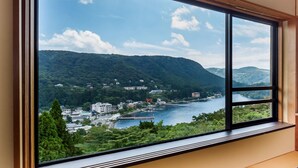 A large window with a view of a town and mountains. - Washintei Hogetsu (Hakone)