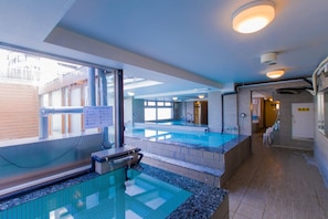 A hotel swimming pool area with a glass barrier, a changing room, and a reception desk. - Ikebukuro Royal Hotel (Tokyo)