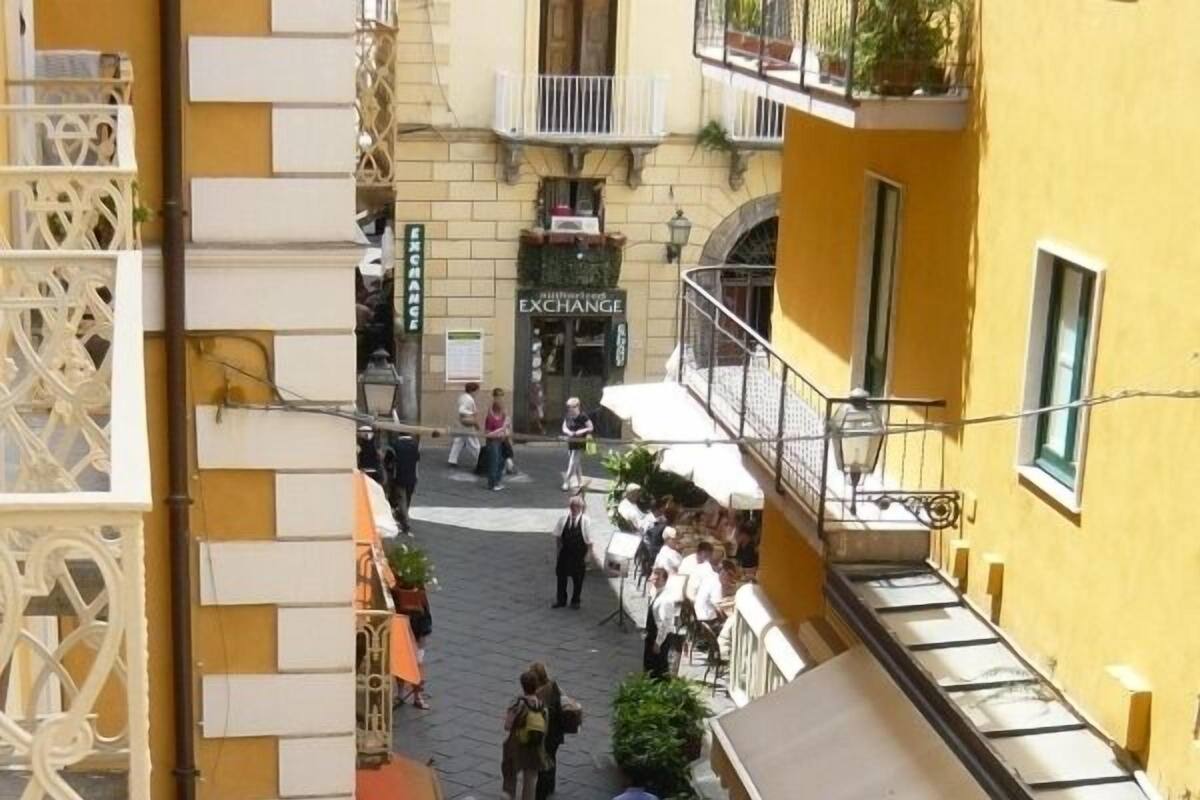 A bustling street scene with a café and a building labeled 'EXCHANGE'.