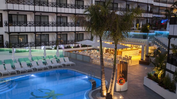 A hotel pool area with a large pool, lounge chairs, and a bar area. - Vanilla Garden Boutique Hotel - Adults Only (Arona)