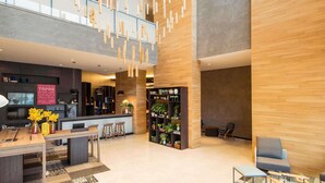 A modern hotel lobby with a bar, seating area, and a staircase. - Novotel São Paulo Berrini (São Paulo)