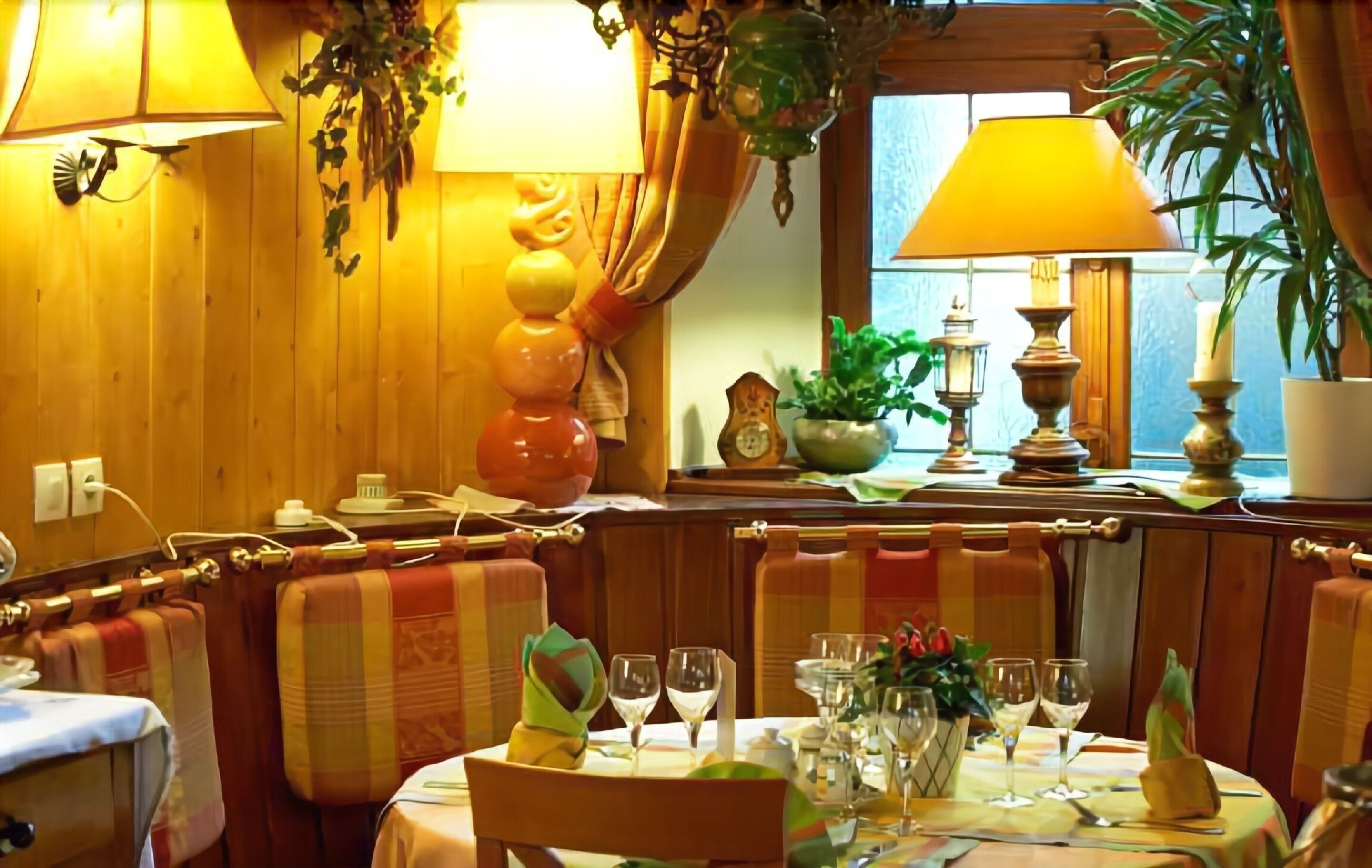 A cozy restaurant with wooden walls, cushioned booths, and a warm ambiance.