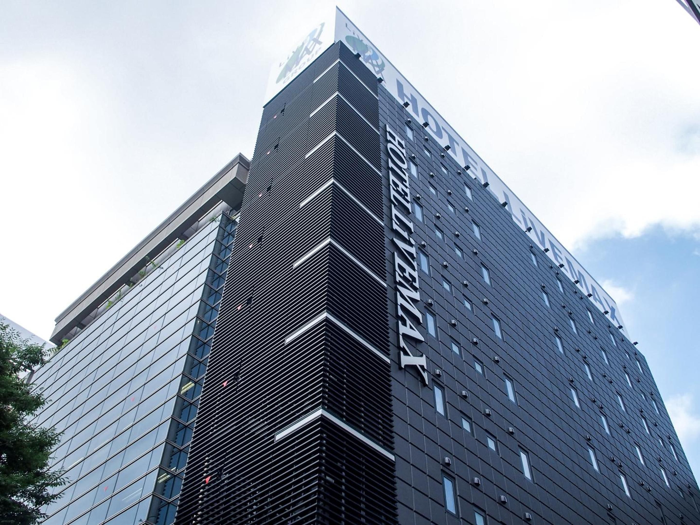 A modern hotel building with a prominent sign.