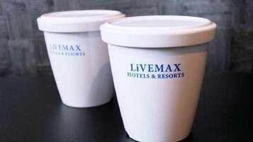 Two white disposable cups with 'Livemax Hotels & Resorts' branding.